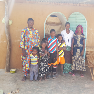Mr. Bonkoungou and his family in front of their NV house